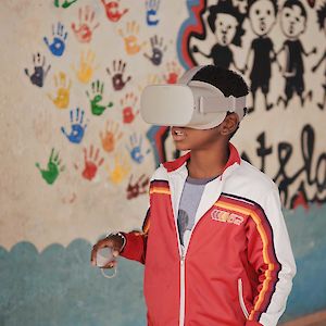 Schoolboy in Cape Verde wearing an Oculus virtual reality headset to learn about turtles